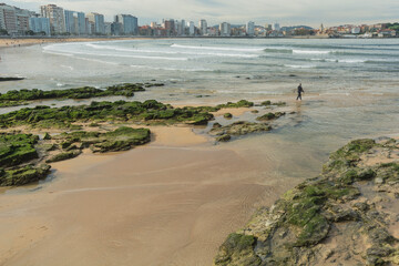 Beach in the morning. Surfer. San Lorenzo beach, Gijon,  Asturias 