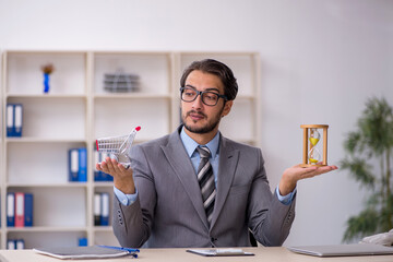 Young male employee in e-commerce concept