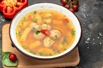 Spicy tomato soup with meatballs and vegetables on a dark background, Restaurant menu, dieting, cookbook recipe top view