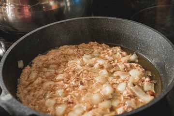 gray pot with cooking food inside during a surf and travel week experience in Somo, Cantabria (Spain)