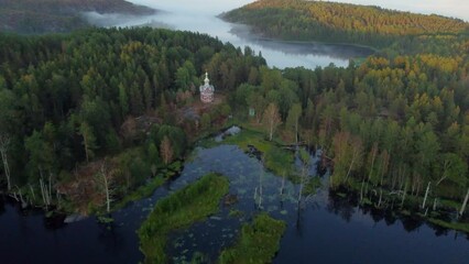 Flight on a drone over the Putsaari island of Lake Ladoga over the Church of St. Sergius and Herman
