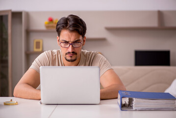 Young male employee working from house