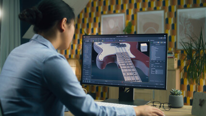 Woman designing 3D prototype of electric guitar using modern personal computer with 3D modeling...
