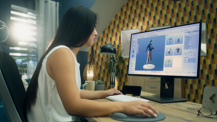Asian 3D designer creating 3D model of style and design of clothes in professional program on...