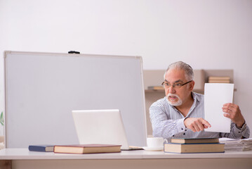 Old male employee working from home during pandemic