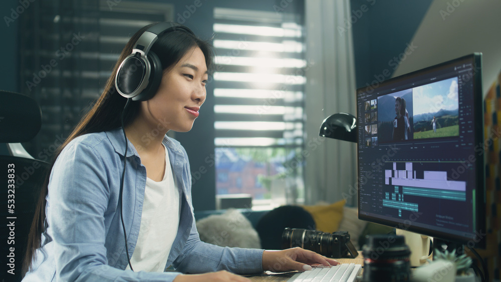 Aufkleber female asian freelancer editing video for customer or travel blogger in program on computer while si