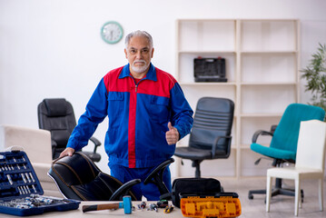 Old male repairman repairing office chair