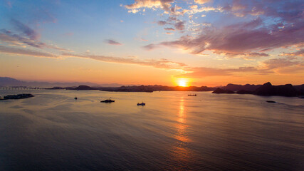 Fototapeta premium Aerial view of Guanabara Bay at dawn, one of Rio de Janeiro's postcards. In the background the mountains of the state.
