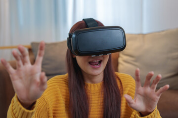 portrait of a young Asian woman using virtual reality simulator headset at home