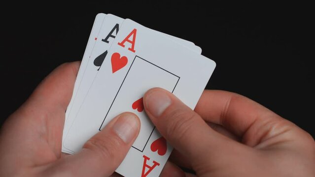 Playing cards, poker hands, four aces on black background
