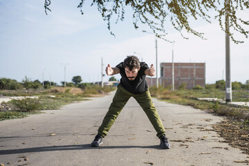 Getting ready to do his best. Portrait of a sporty young man stretching his back while exercising outdoors.