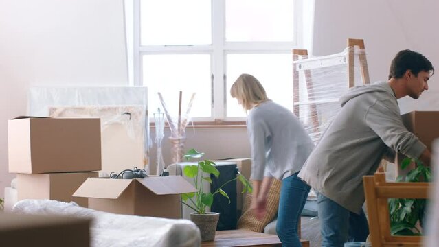 Real estate, home and couple hug after moving into property, house or apartment to live together. Love, partnership and commitment for happy woman, man or young homeowner with box in new family home