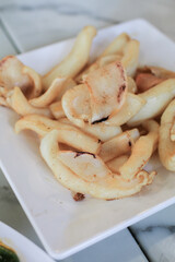 Deep fried sun dried squid  Or calamari on white plate, Thailand Food Style.