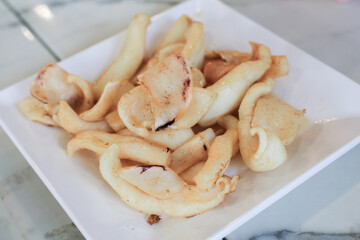 Deep fried sun dried squid  Or calamari on white plate, Thailand Food Style.