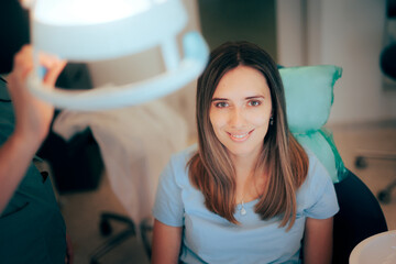Happy Patient Smiling Siting in the Chair at the Dentist. Cheerful optimistic patient waiting for...