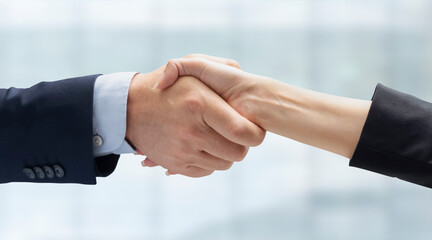 Close up of business people handshake in the office after meeting - Successful business man and business woman handshaking after good deal - isolated on white -  People Connection Deal Concept