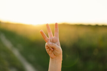 The boy shows with his fingers the number three or trident coat of arms of Ukraine. Ukrainian...