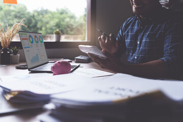 Businessman calculating saving account balance, account and saving concept