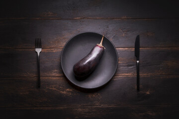 blue dark squash on a black plate still life