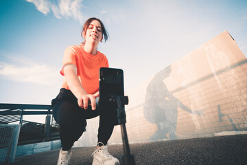 Young woman preparing the phone to record and greeting the followers phone. Young streamer working