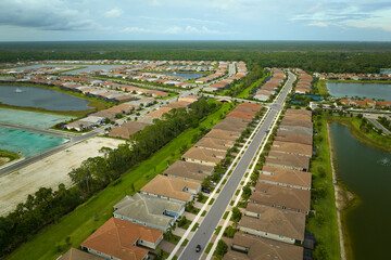 Aerial view of tightly packed homes in Florida closed living clubs. Family houses as example of real estate development in american suburbs