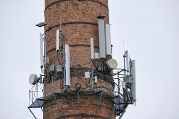 Closeup and detailed view of various GPS, cellphone, 3G, 4G and 5G equipped telecommunication tower