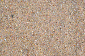 Flat view of clean yellow sand surface covering seaside beach. Sandy texture