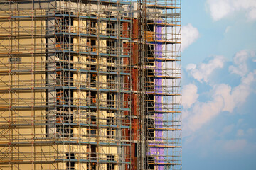 Tower cranes and frame structure of high residential apartment buildings at construction site. Real estate development
