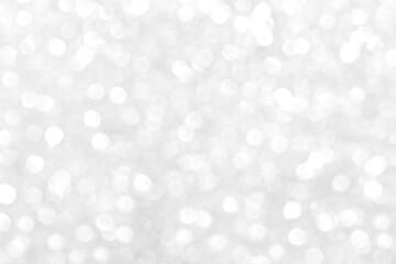 Abstract silver and white bokeh light shiny background.  The concept of New Year, Christmas, Wedding anniversary, Winter and all celebration background concepts. 