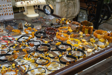 Colorful showcases of traditional jewelry stores and amber gemstone products in city market square in Gdansk Poland Mariacka street. Souvenir jewelry for sale as gift. Variety assortment of souvenirs