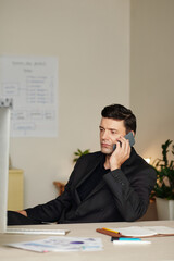 Businessman Calling on Phone to Colleague