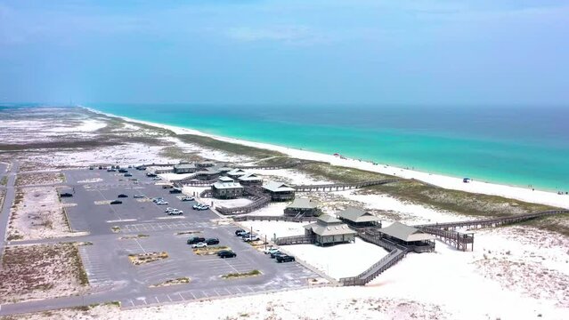 Drone flying over the public beach access in Navarre FL on a cloudy day but with beautiful white beaches and a view of the Gulf of Mexico.