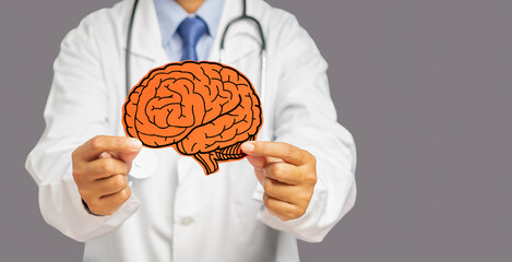 Doctor in uniform holding a white head with a red brain symbol while standing on a gray background