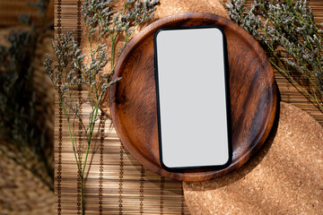 mockup blank screen smartphone on wood food plate on mat