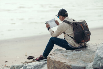 Tourists hold maps to find attractions, restaurants or hotels. backpacker and travel concept.