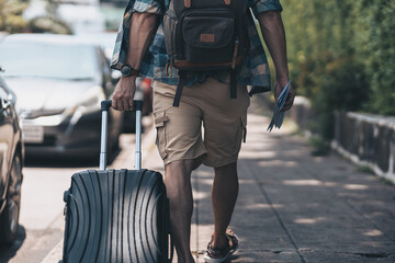 Tourists drag their luggage on the road to find a hotel to stay. travel concept..