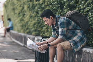 Tourists hold maps to find attractions, restaurants or hotels on the road in the city. backpacker and travel concept.