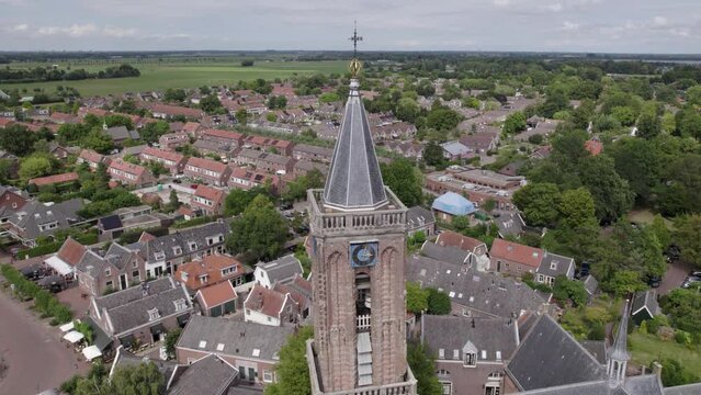 Aerial view of a church tower in a Dutch village, a clock on a church tower, religious building