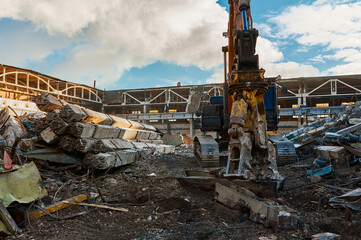 Excavator destroyer removes debris winter day