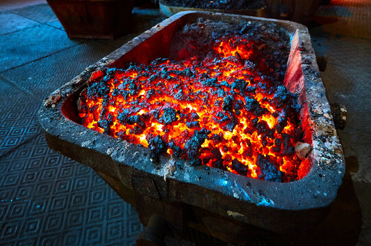 Bucket with hot melted smelter slag in production workshop