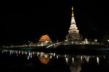 Naklejka premium illustration, book cover, image of a temple pagoda at night, decorated with lights, dark sky