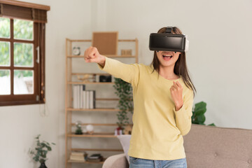 Leisure activities concept, Young woman playing boxing games to experience virtual with glasses VR