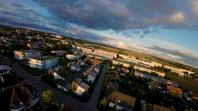 Aerial view of a street surrounded by houses with young families in the new quarter of the city of Svitavy in the Czech Republic. Romantic drone view at sunset