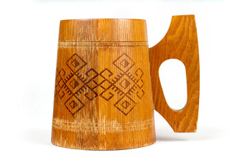 An old wooden mug with ornament.
