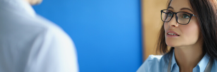 A woman in the office explains to a man a report