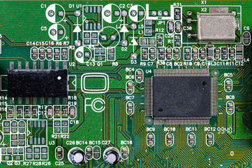 closeup shot of microchip on green printed circuit board, computer motherboard with components
