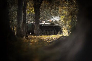 Toned photograph. A selective focus shot of an abandoned military tank in forest