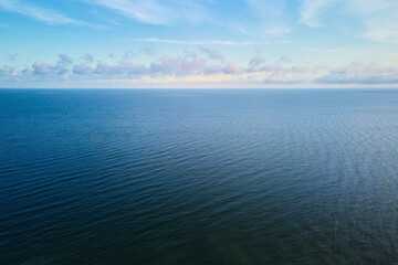 Drone flight over calm sea landscape with cloudy sky, Baltic sea panorama, aerial view