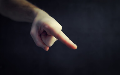 Finger gestures. Male hands on a gray background. Gesticulation with hands.