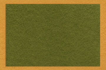Texture of craft dark green color paper background with yellow border, macro. Vintage kraft olive...
